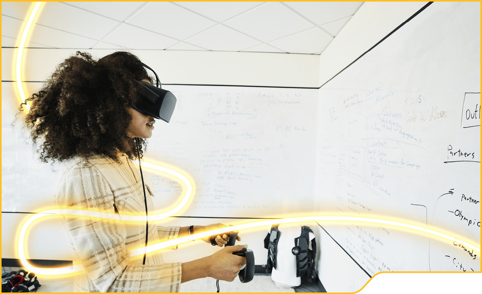 Female engineer testing program on virtual reality headset in computer lab